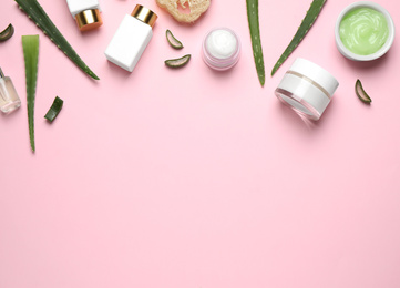 Photo of Flat lay composition with aloe vera and cosmetic products on pink background. Space for text