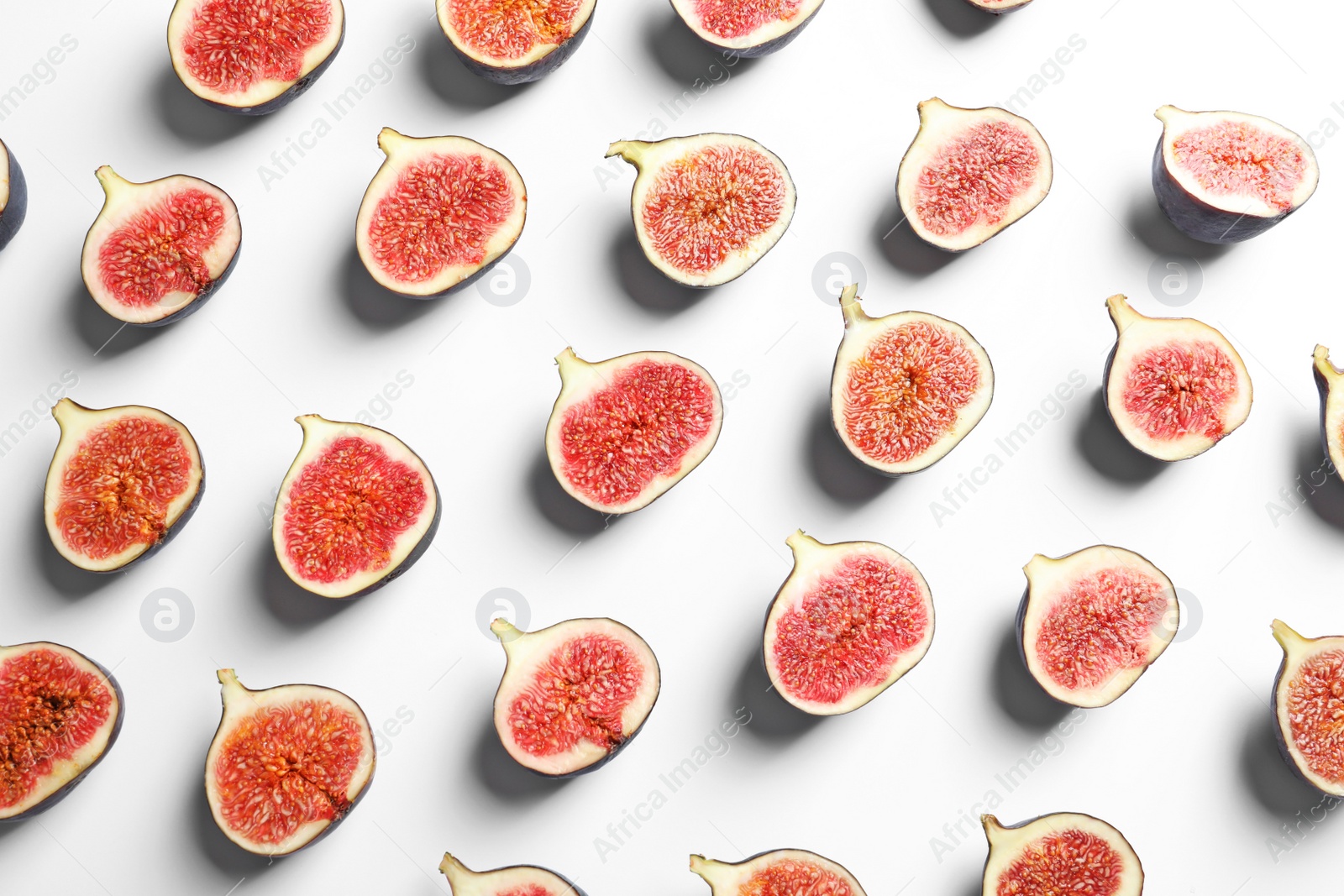 Photo of Cut ripe figs on white background, top view