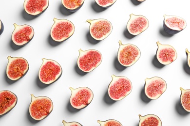 Photo of Cut ripe figs on white background, top view