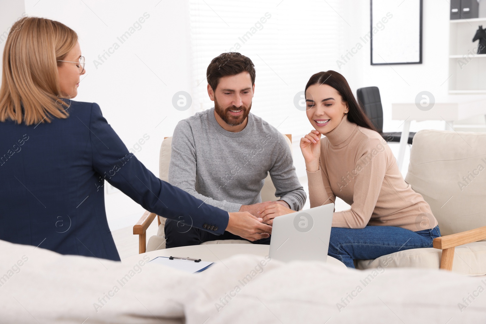 Photo of Real estate agent consulting couple in office