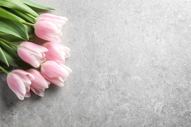 Photo of Beautiful tulips for Mother's Day on grey background, top view