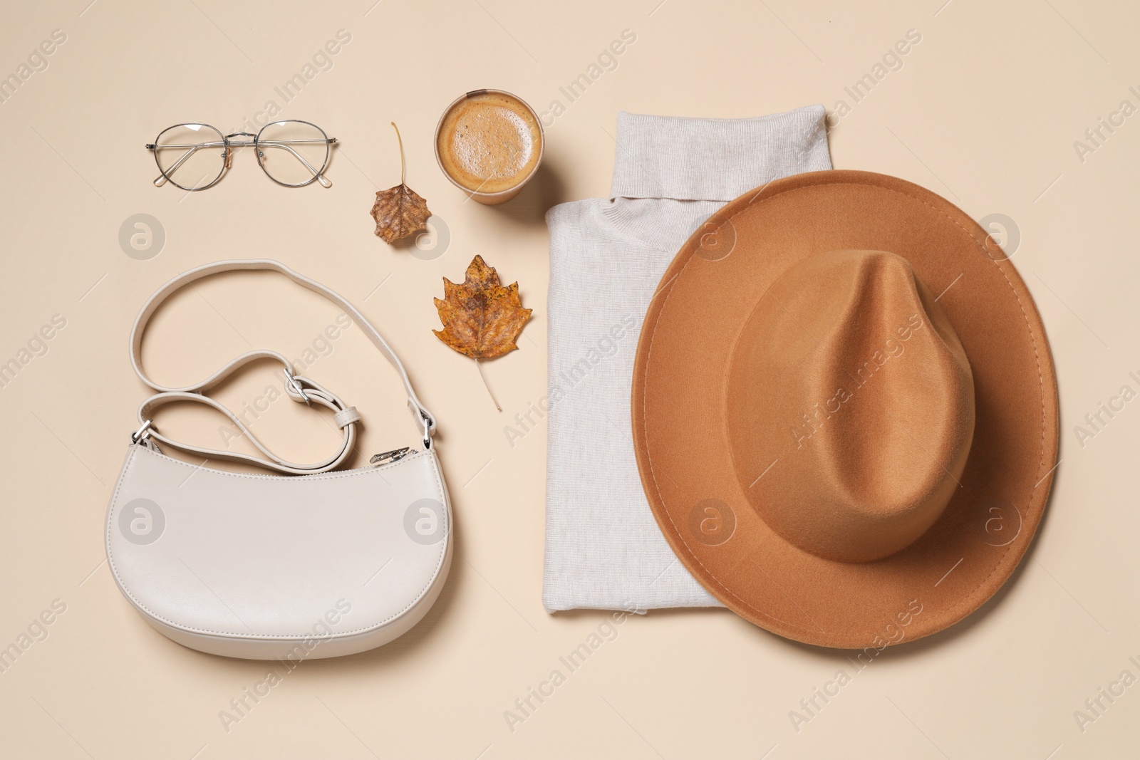 Photo of Flat lay composition with stylish hat on beige background