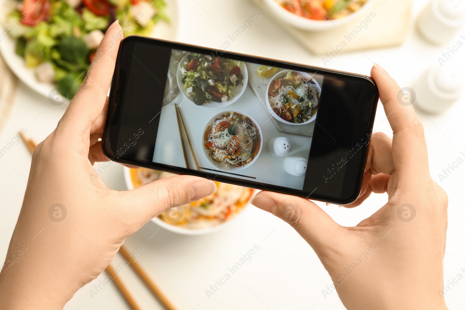 Photo of Blogger taking picture of lunch at table, top view