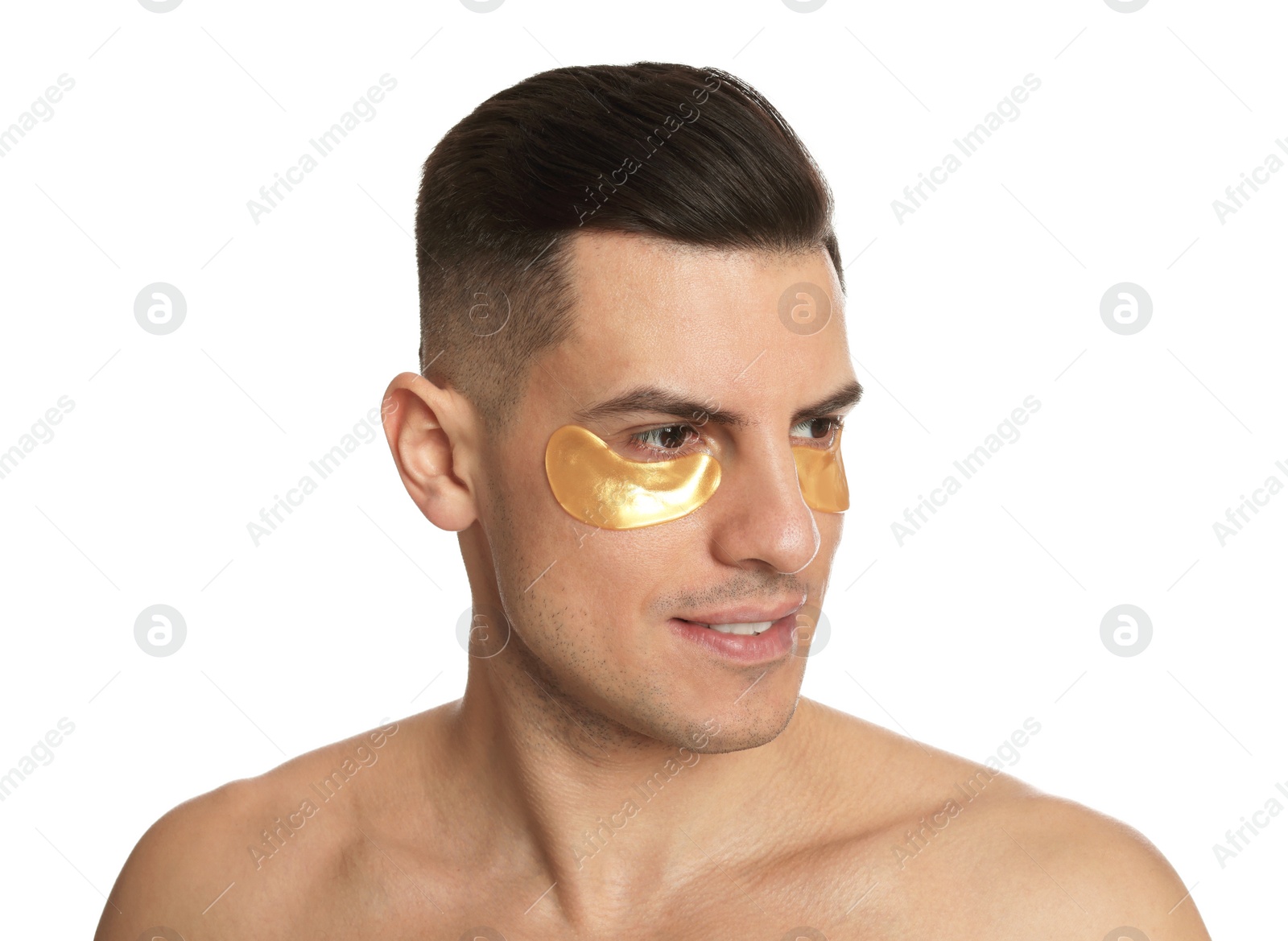 Photo of Man with golden under eye patches on white background