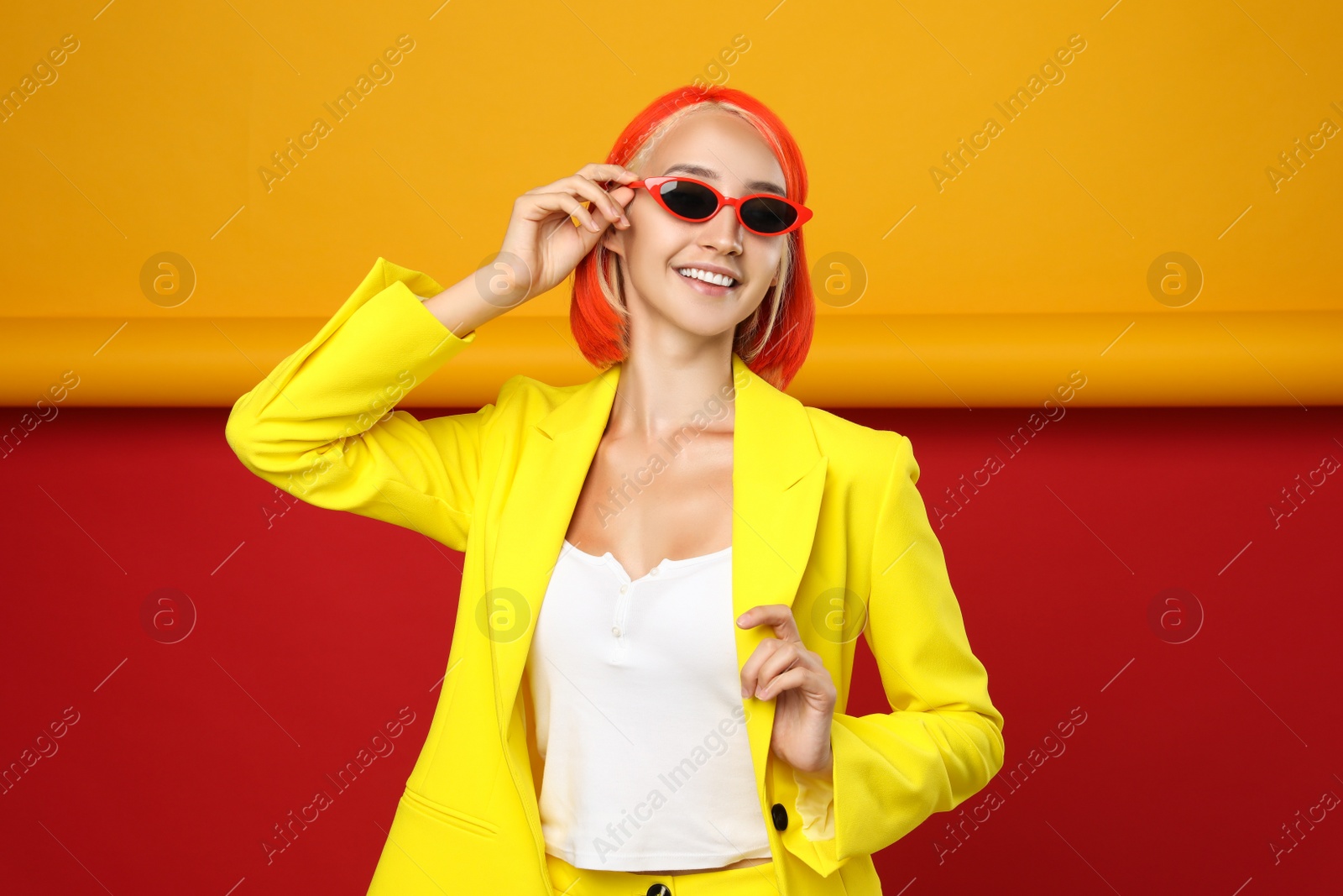 Photo of Beautiful young woman with bright dyed hair on color background
