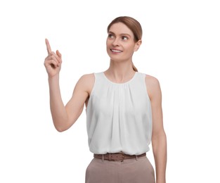 Beautiful happy businesswoman pointing at something on white background