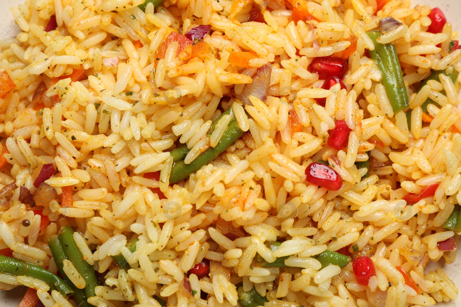 Photo of Tasty rice pilaf with vegetables as background, closeup