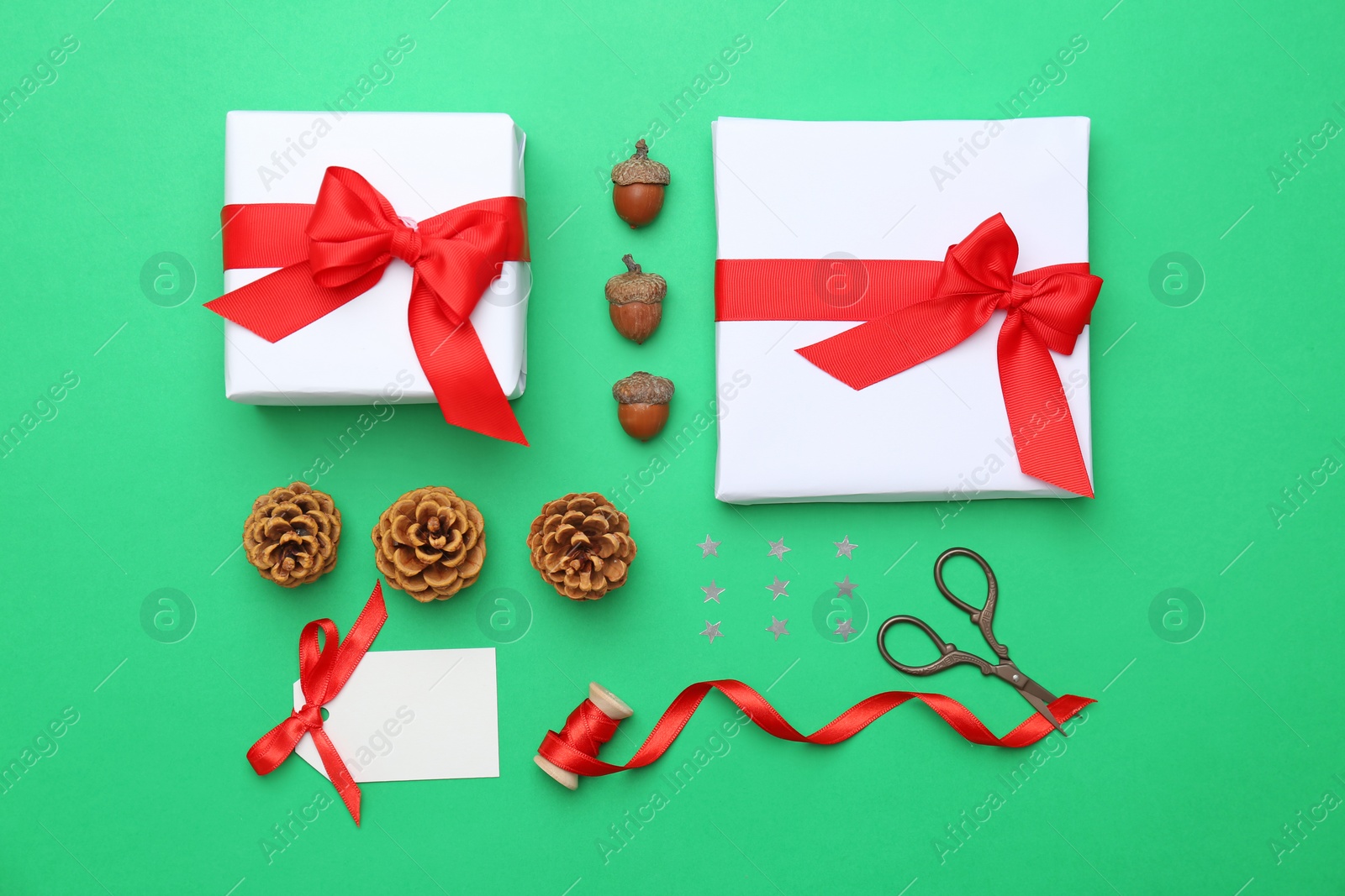 Photo of Beautiful Christmas gift boxes with ribbons and decors on color background, top view