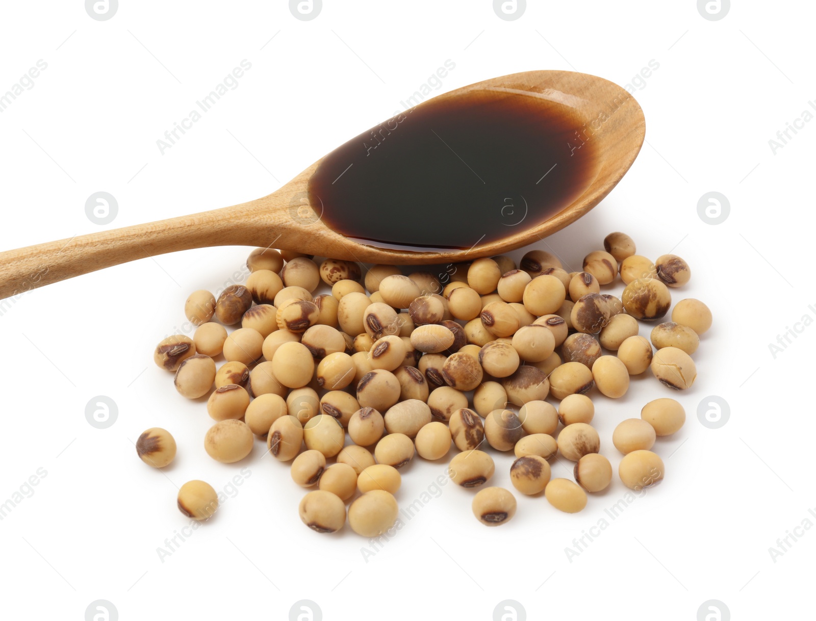 Photo of Tasty soy sauce in spoon and soybeans isolated on white