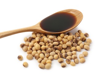 Tasty soy sauce in spoon and soybeans isolated on white