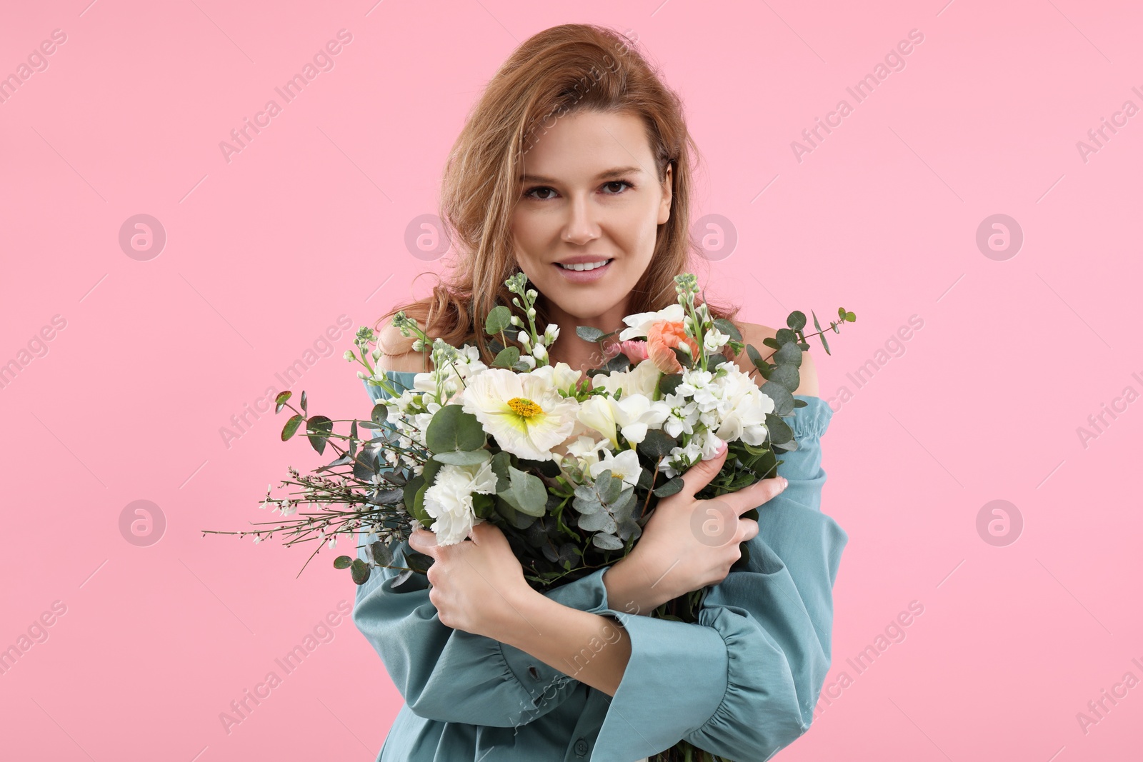 Photo of Beautiful woman with bouquet of flowers on pink background