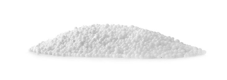 Pellets of ammonium nitrate on light grey background. Mineral fertilizer