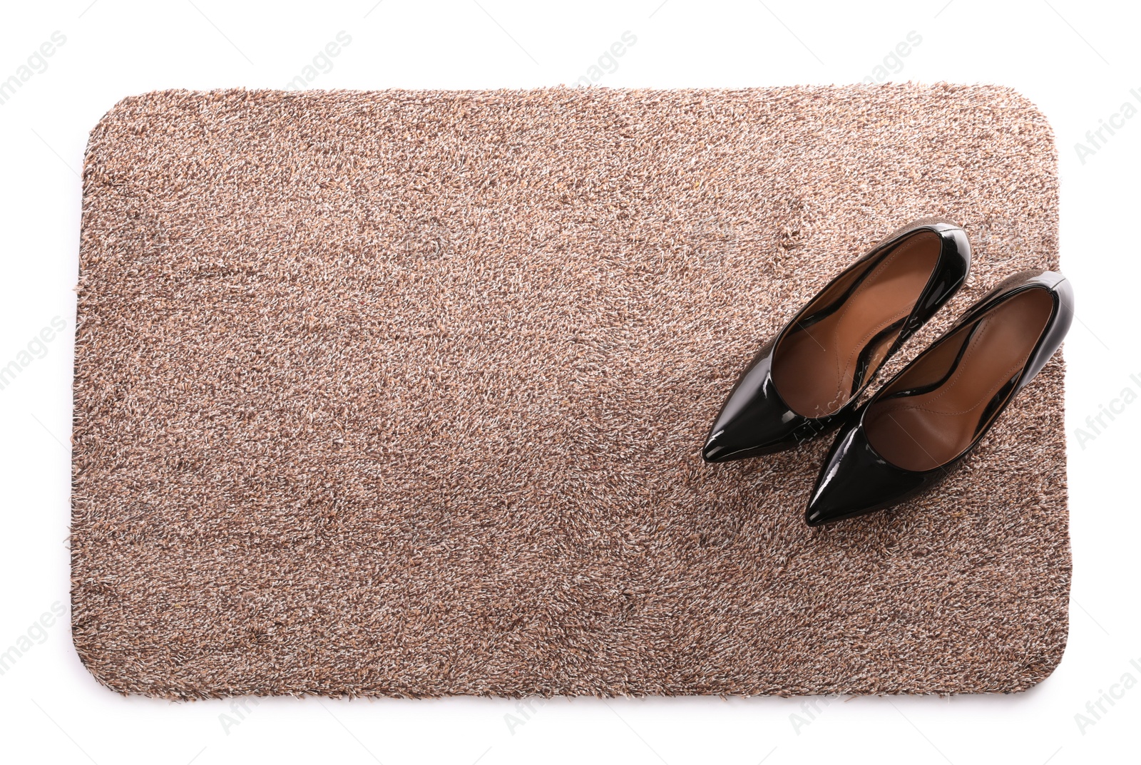 Photo of Stylish door mat with high heeled shoes on white background, top view