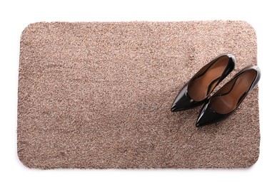 Photo of Stylish door mat with high heeled shoes on white background, top view