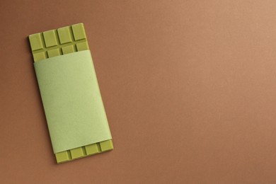 Photo of Tasty matcha chocolate bar on brown background, top view. Space for text