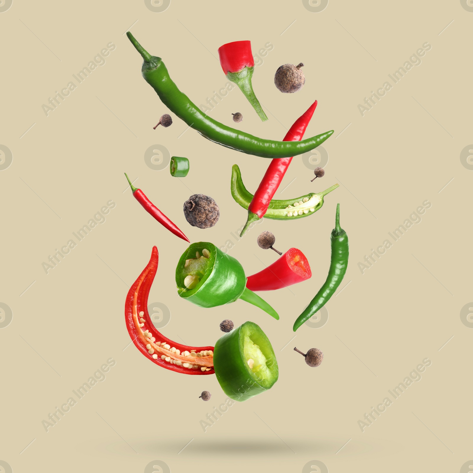 Image of Different spices falling on dark beige background