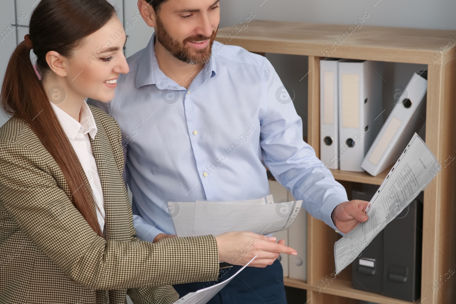 Photo of Businesspeople working together with documents in office