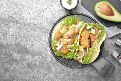 Photo of Delicious fish tacos served on grey table, flat lay with space for text