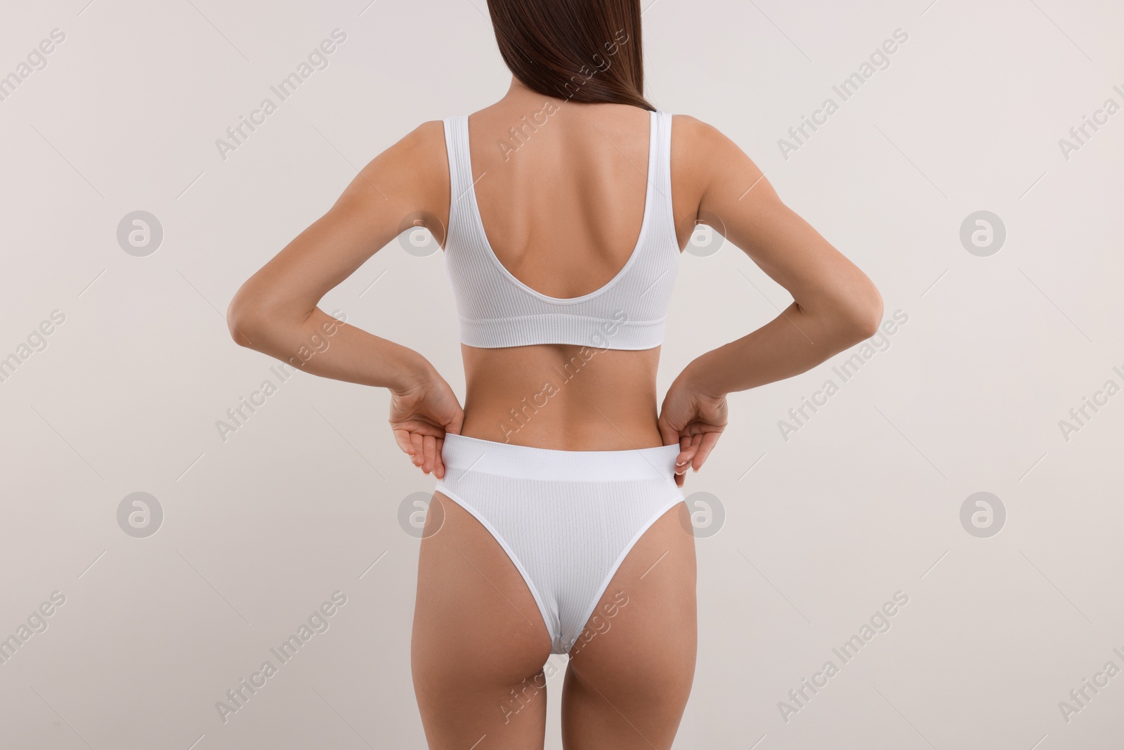 Photo of Young woman in stylish bikini on white background, closeup
