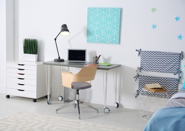 Photo of Modern child room interior with comfortable bed and desk