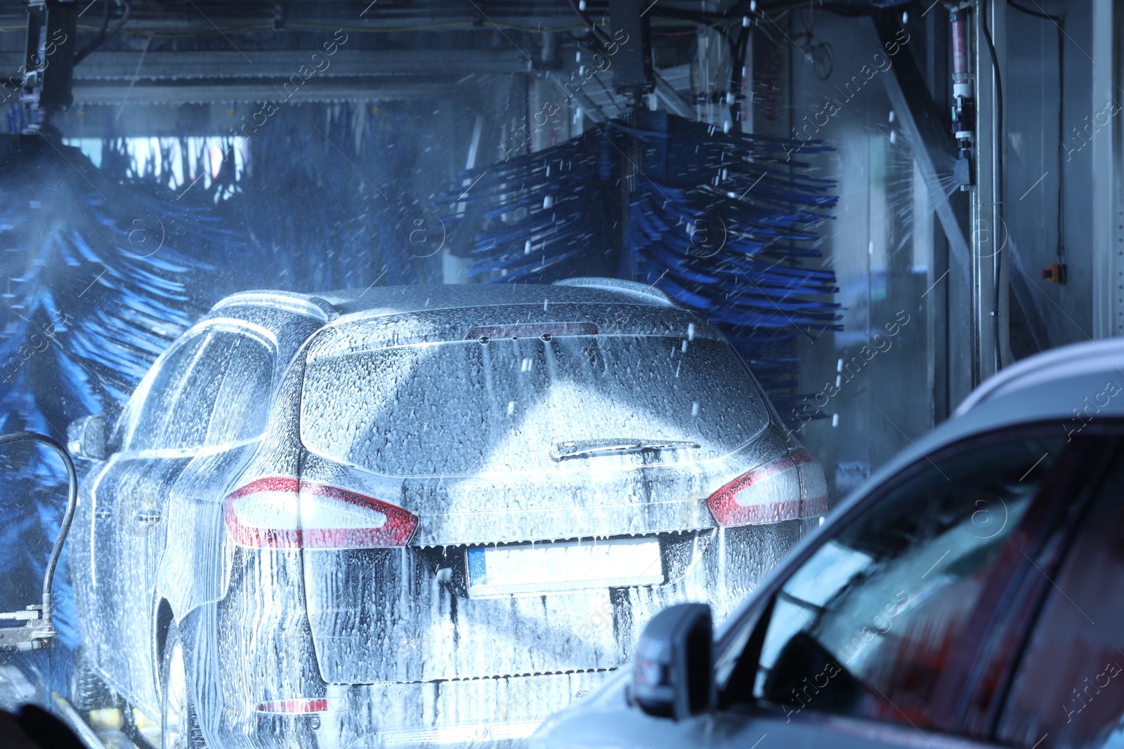 Photo of Modern auto undergoing cleaning at car wash