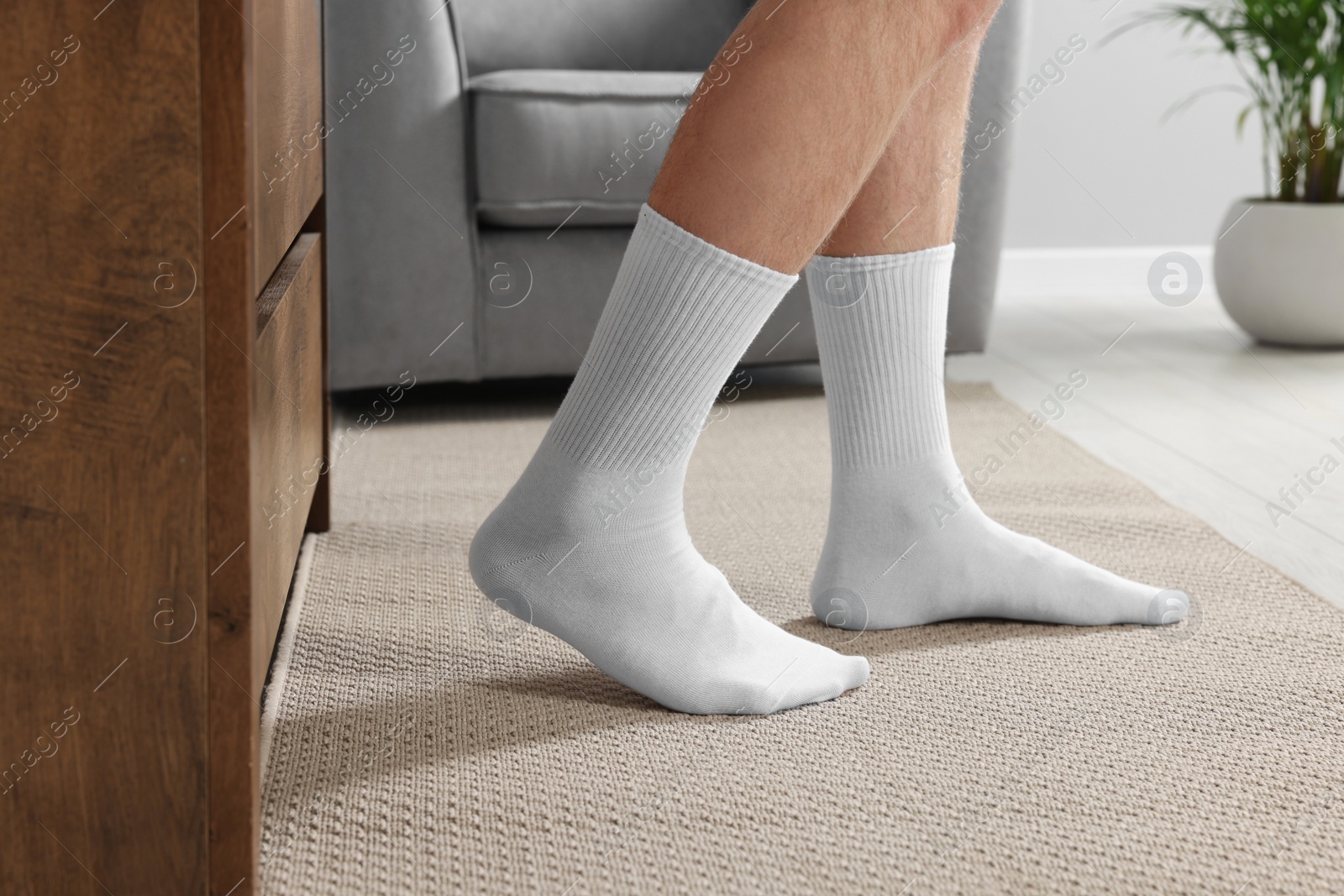 Photo of Man in stylish white socks indoors, closeup