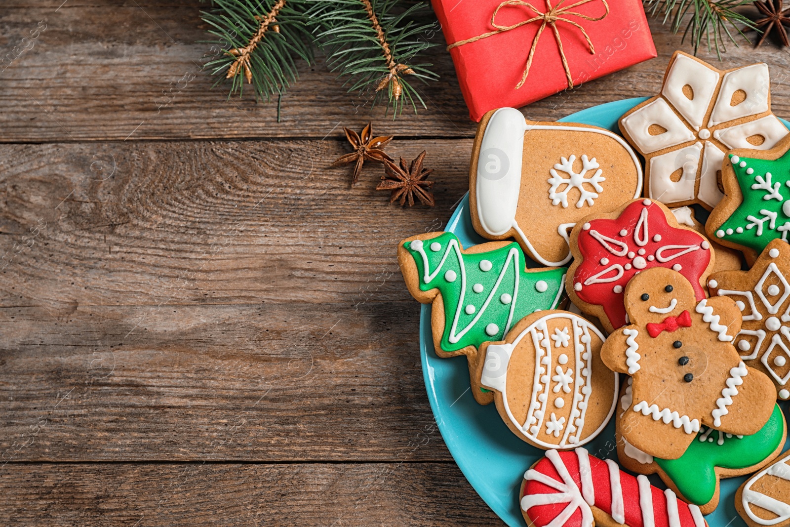 Photo of Flat lay composition with tasty homemade Christmas cookies on wooden table. Space for text