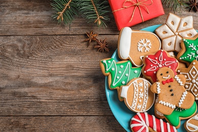 Photo of Flat lay composition with tasty homemade Christmas cookies on wooden table. Space for text