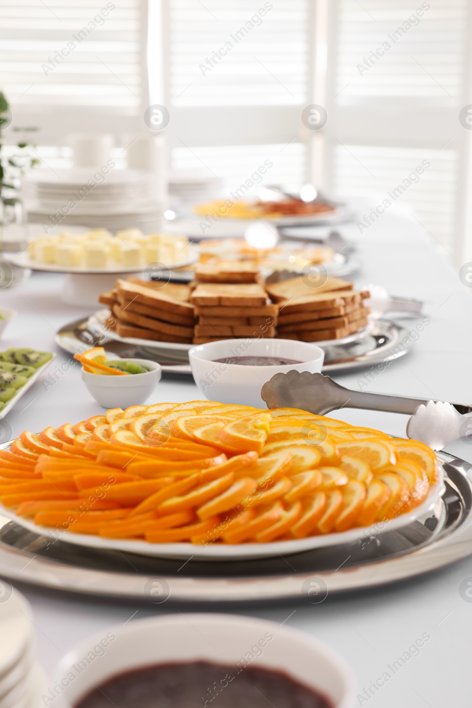 Photo of Different meals for breakfast on white table indoors. Buffet service