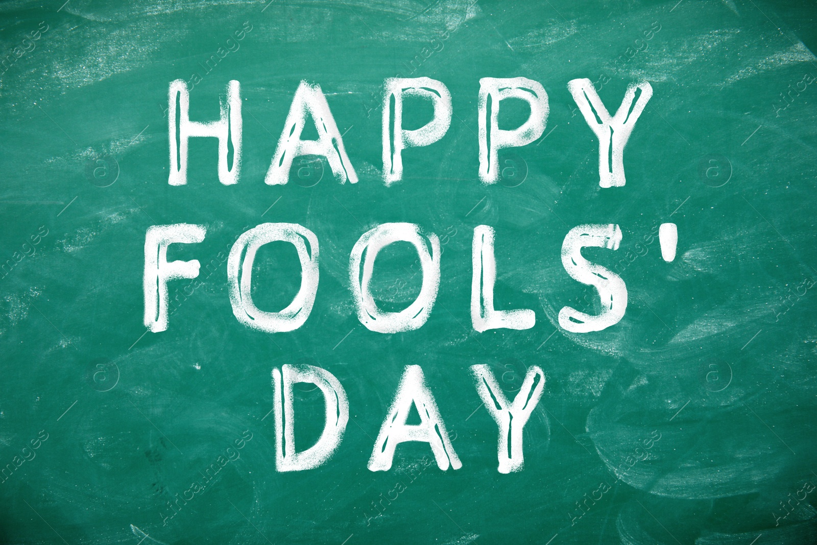Image of Text Happy Fool's Day on green chalkboard