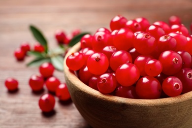 Photo of Tasty ripe cranberries on brown table, closeup