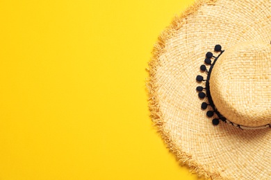 Stylish straw hat on color background, top view with space for text. Beach accessories