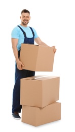 Portrait of moving service employee with cardboard boxes on white background