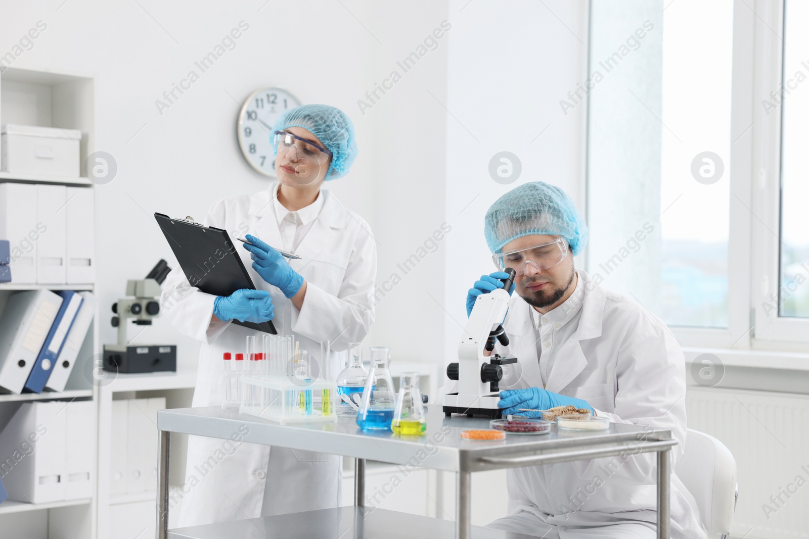 Photo of Quality control. Food inspectors checking safety of products in laboratory