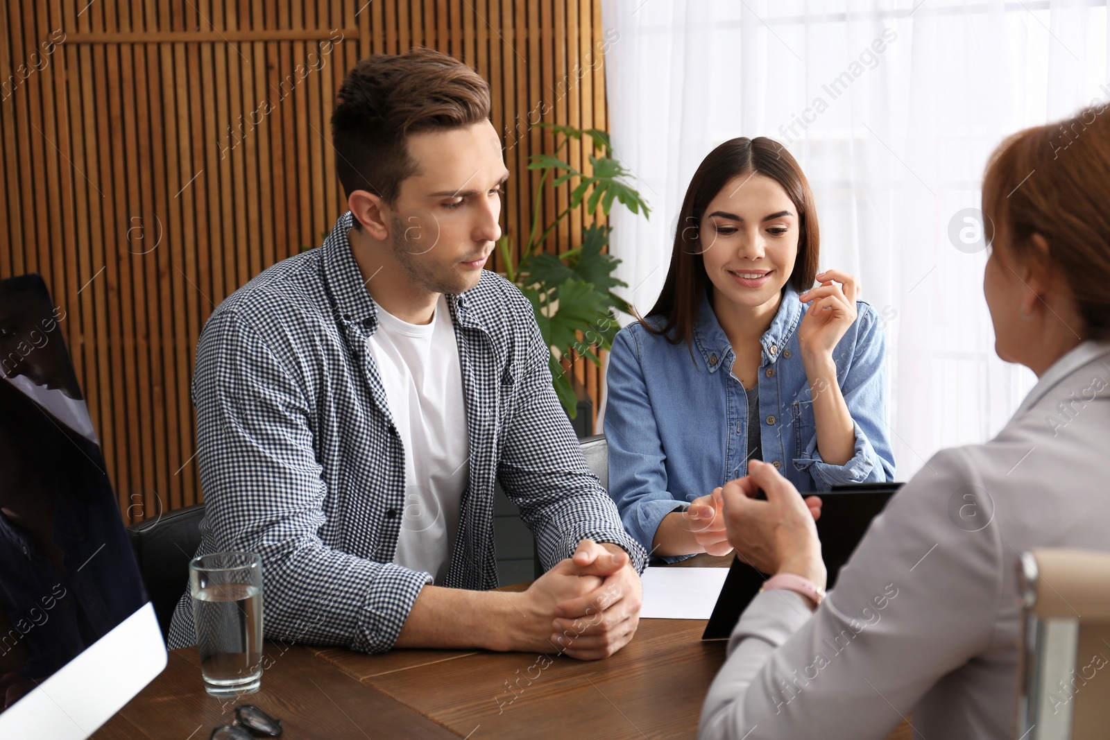 Photo of Lawyer having meeting with young couple in office