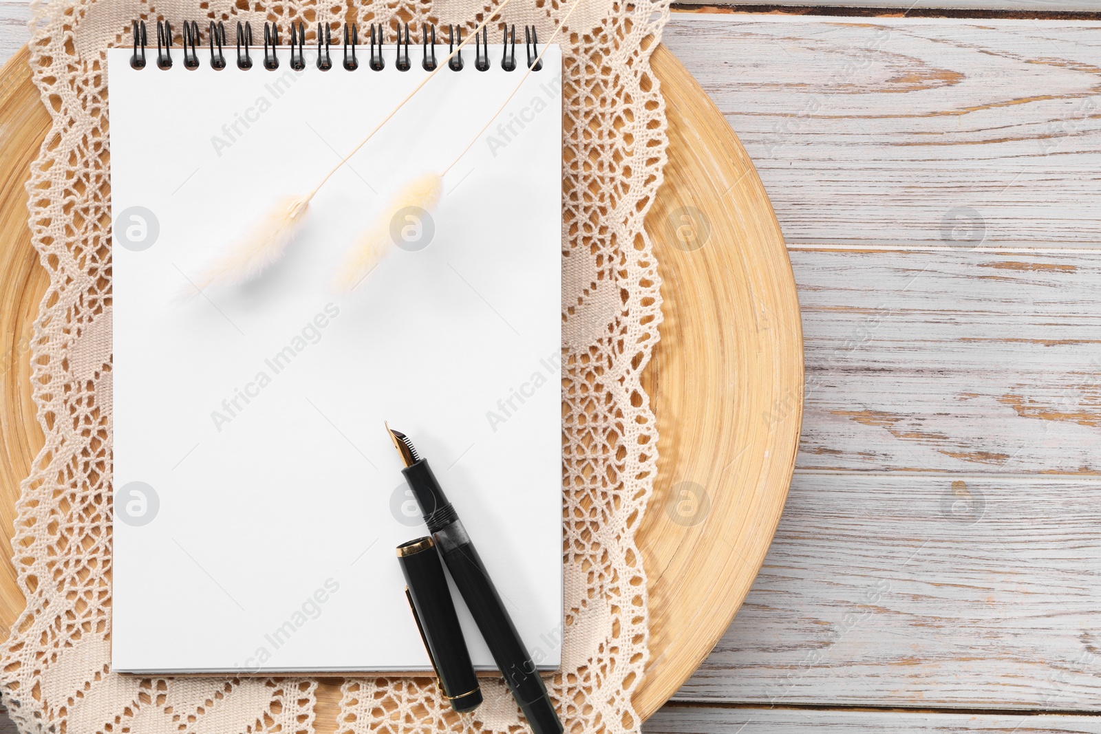 Photo of Guest list. Notebook, pen, spikelets and lace ribbon on wooden background, flat lay. Space for text