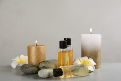 Beautiful composition with spa stones and candles on table