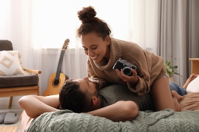 Photo of Lovely couple enjoying each other on bed at home