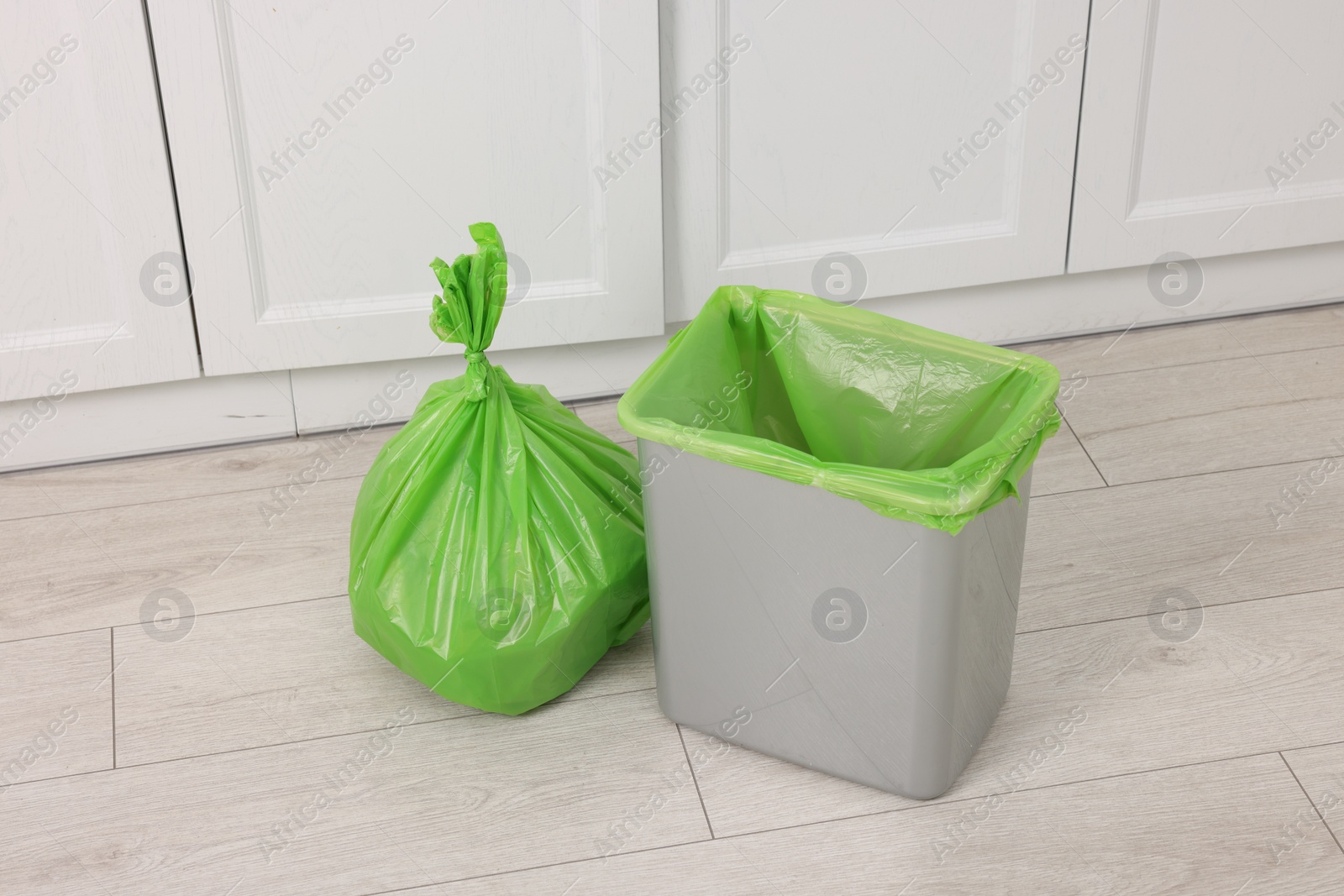 Photo of Plastic garbage bag and trash can indoors