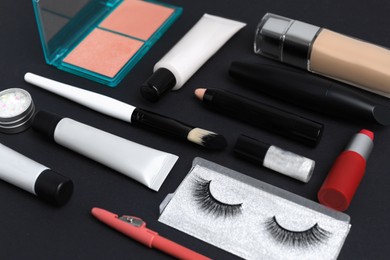 Set of makeup products on black background