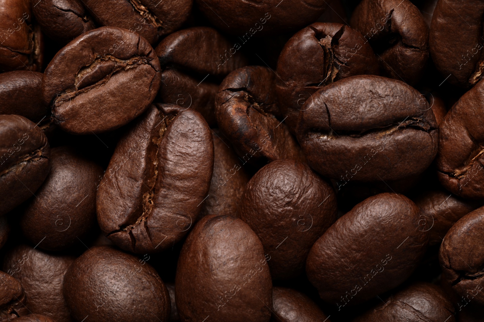 Photo of Aromatic roasted coffee beans as background, closeup