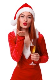 Photo of Young woman in red dress and Santa hat with glass of wine blowing kiss on white background. Christmas celebration