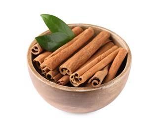 Photo of Cinnamon sticks and green leaves in bowl isolated on white