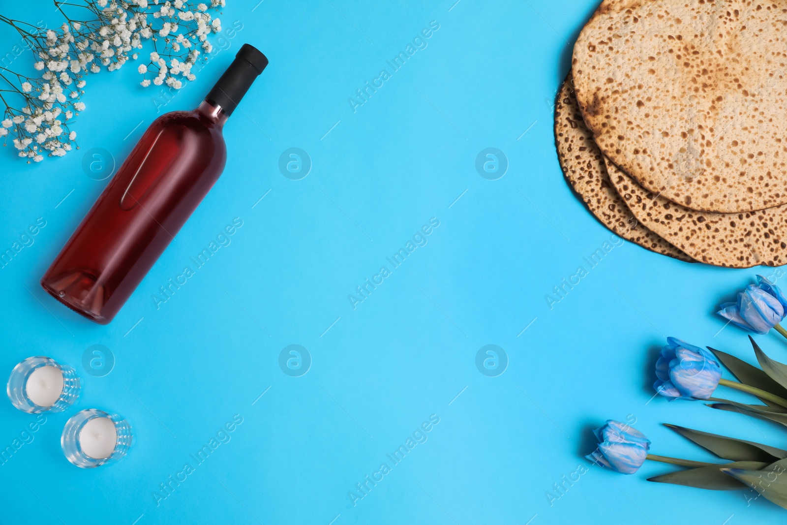 Photo of Flat lay composition with matzos on light blue background, space for text. Passover (Pesach) celebration