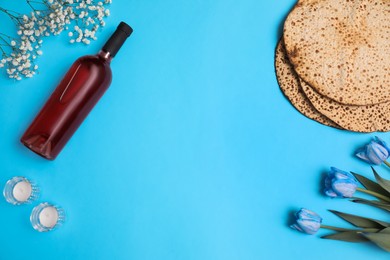 Photo of Flat lay composition with matzos on light blue background, space for text. Passover (Pesach) celebration