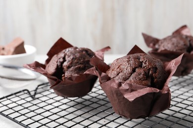 Photo of Tasty chocolate muffins on grey table, closeup