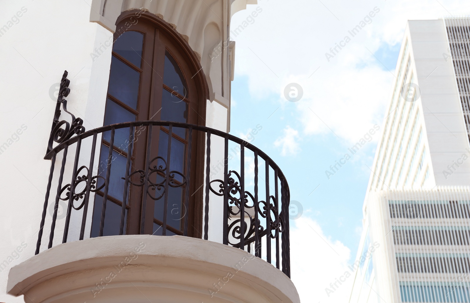 Photo of Exterior of building with beautiful window and balcony, low angle view