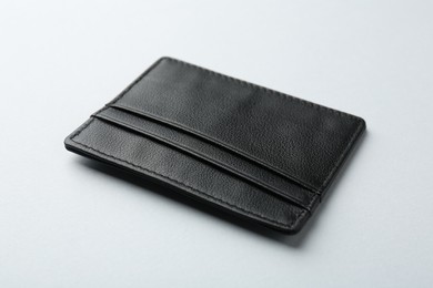 Photo of Empty leather card holder on light grey background