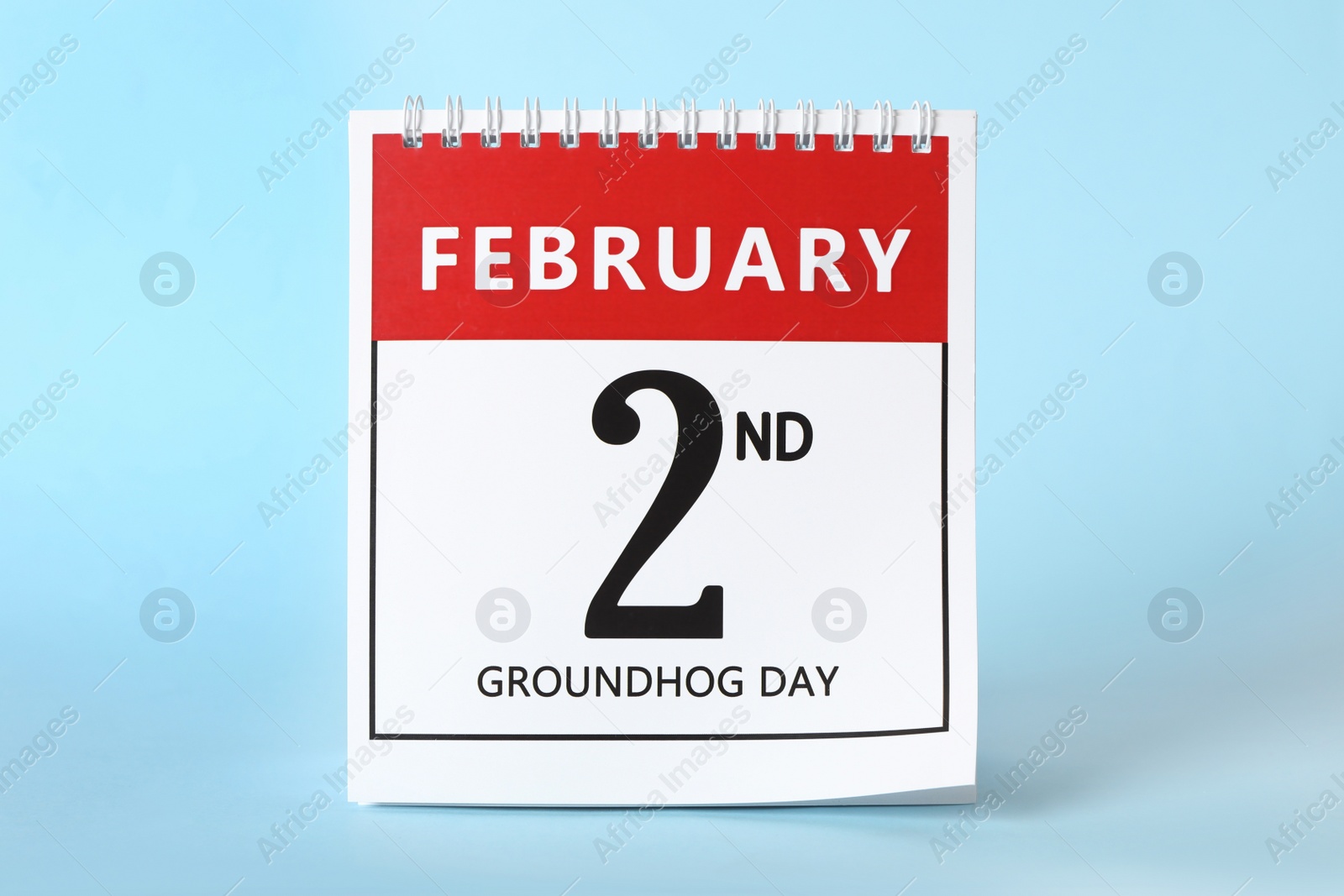 Photo of Calendar with date February 2nd on light blue background. Groundhog day