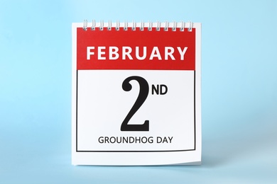 Calendar with date February 2nd on light blue background. Groundhog day